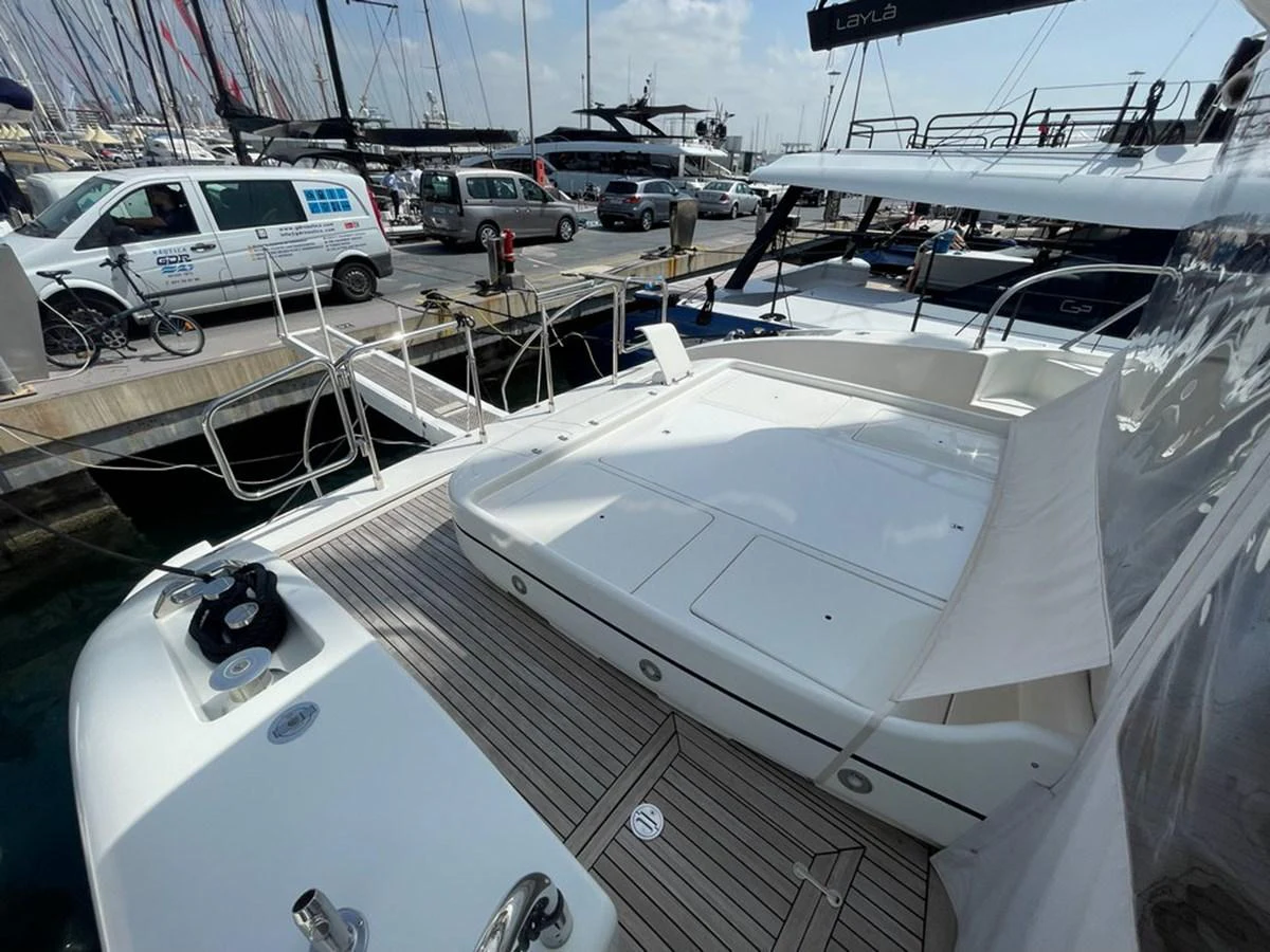 The yacht's aft deck features a spacious lounging area with a view of the marina. aboard MANGUSTA 72 Yacht for Sale