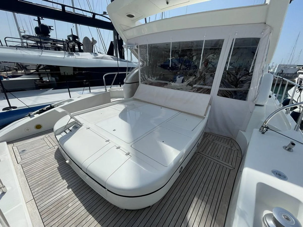 The aft deck features a spacious sunpad with a retractable canopy, perfect for relaxation. aboard MANGUSTA 72 Yacht for Sale