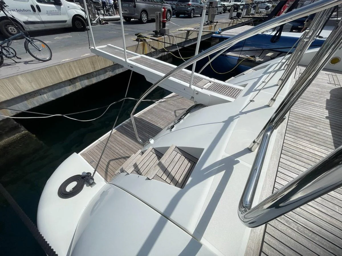The image captures a detailed view of the yacht's boarding area with a gangway leading to the dock. aboard MANGUSTA 72 Yacht for Sale
