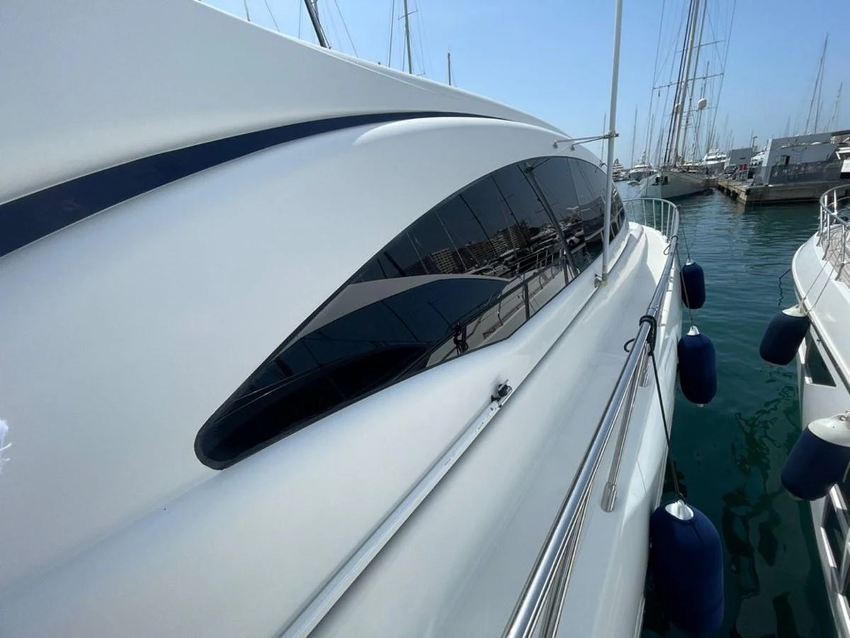 The sleek exterior of the yacht is showcased docked at the marina. aboard MANGUSTA 72 Yacht for Sale