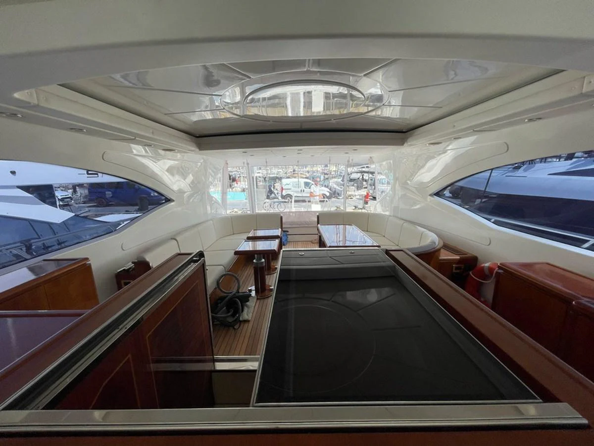 The salon offers a spacious and elegant area with ample seating and large windows for natural light. aboard MANGUSTA 72 Yacht for Sale