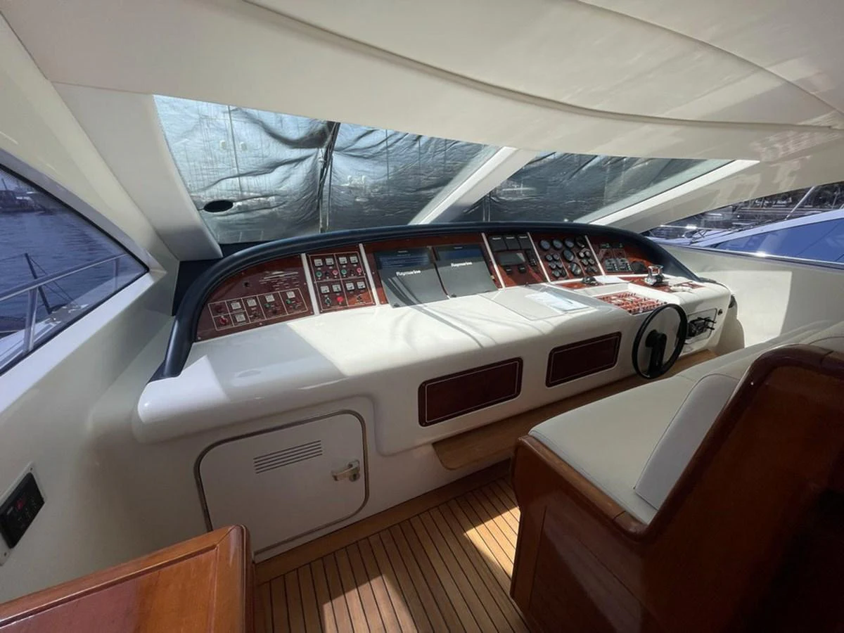The helm station features advanced navigation equipment and comfortable seating. aboard MANGUSTA 72 Yacht for Sale