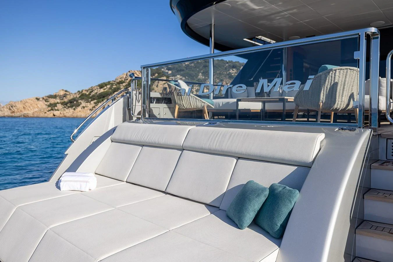 The aft deck features a luxurious sunbathing area with plush cushions and a stunning view of the sea. aboard MAI DIRE MAI Yacht for Sale