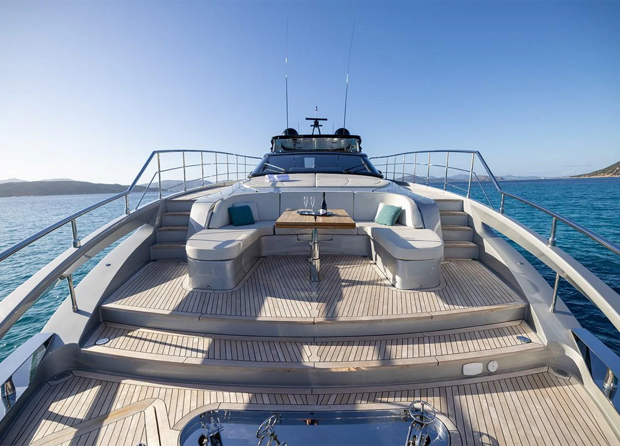 The yacht features a spacious bow seating area with plush cushions and a central table, perfect for enjoying the ocean views. aboard MAI DIRE MAI Yacht for Sale