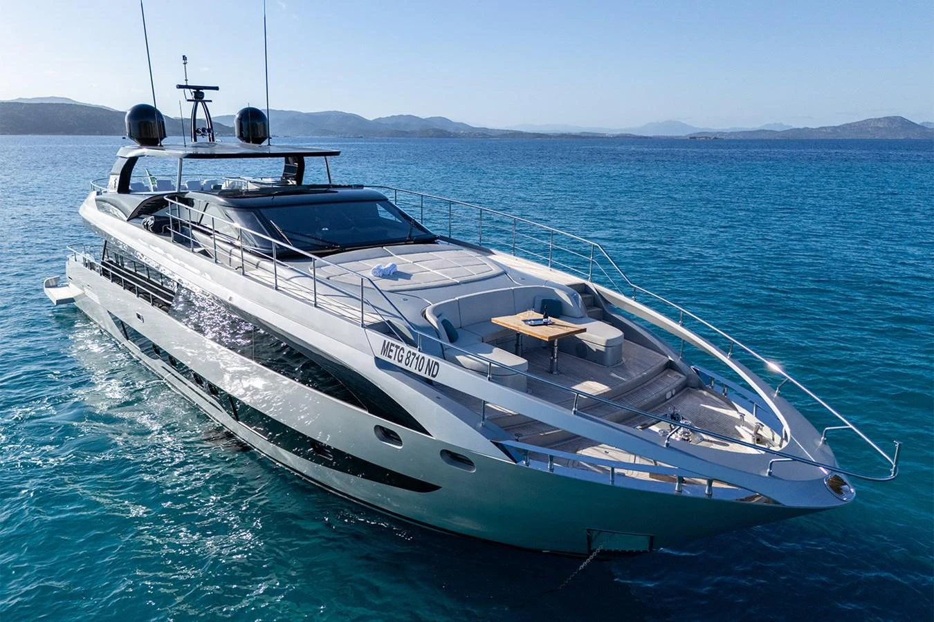 A sleek and modern yacht cruising on clear blue waters with a spacious deck area. aboard MAI DIRE MAI Yacht for Sale