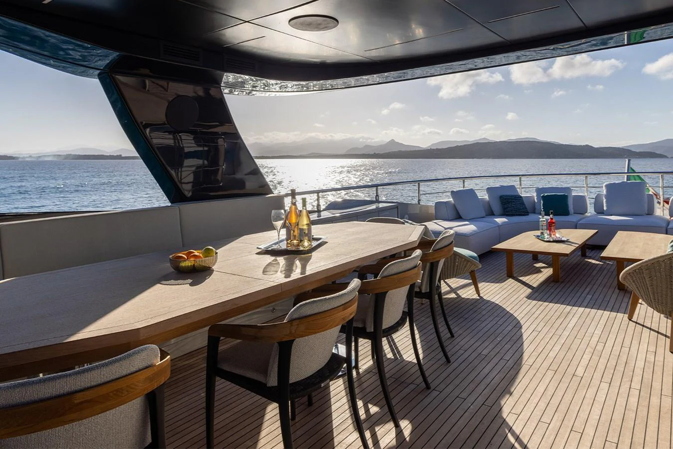 The aft deck features a spacious dining area with a stunning view of the sea. aboard MAI DIRE MAI Yacht for Sale