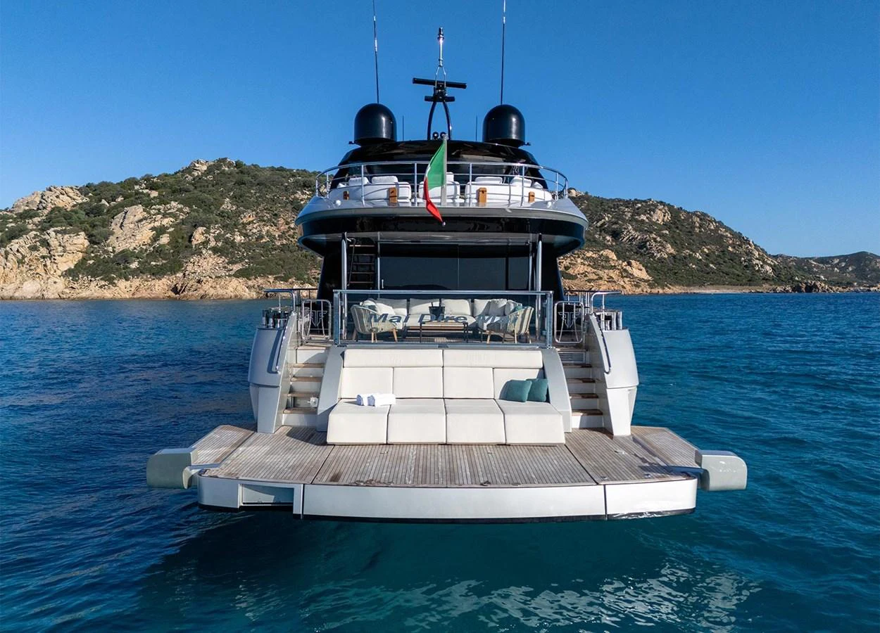 The yacht's aft deck features a spacious lounging area with a stunning view of the surrounding waters. aboard MAI DIRE MAI Yacht for Sale