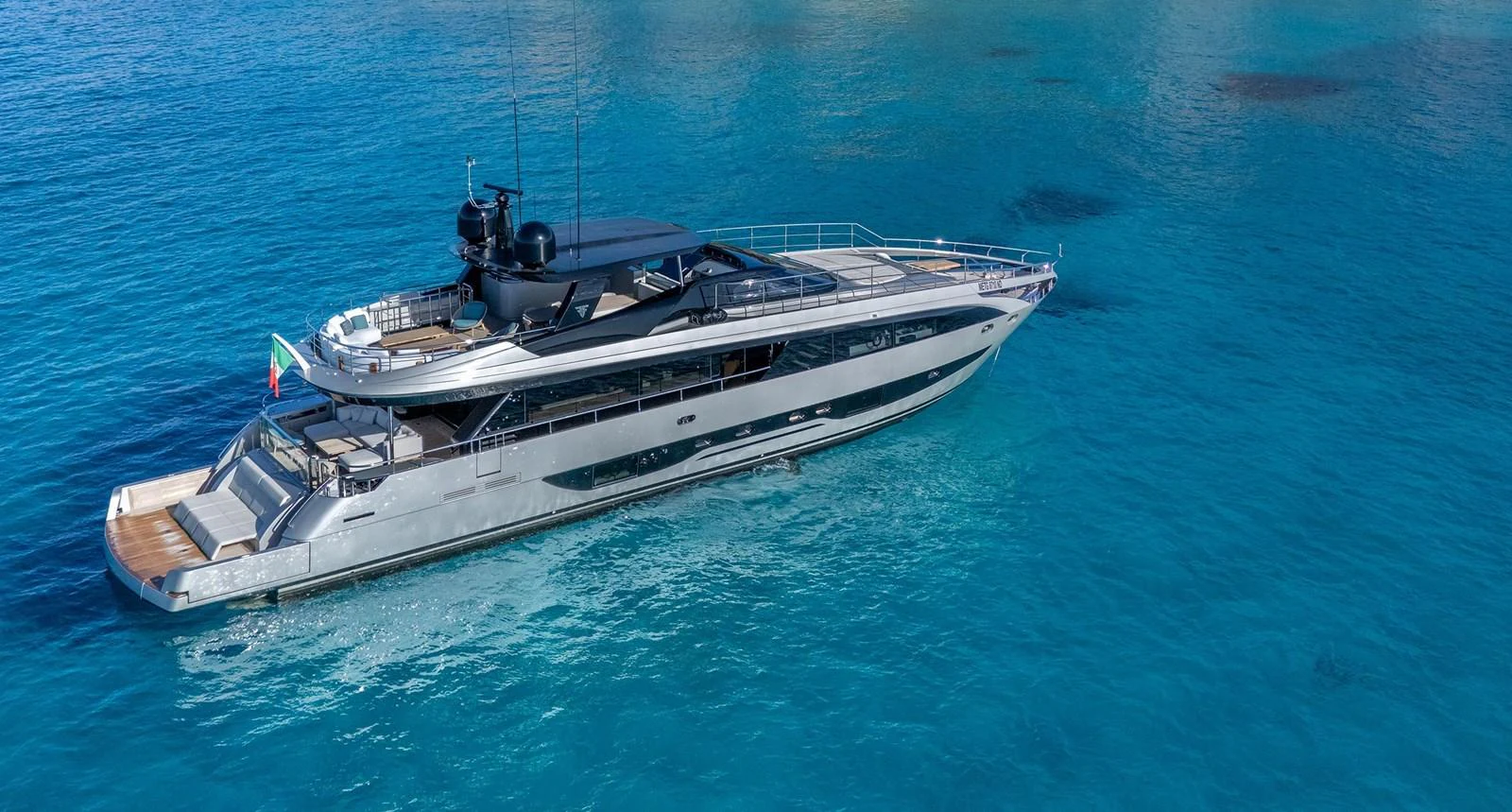A sleek and modern yacht glides through clear blue waters, showcasing its elegant design and spacious decks. aboard MAI DIRE MAI Yacht for Sale