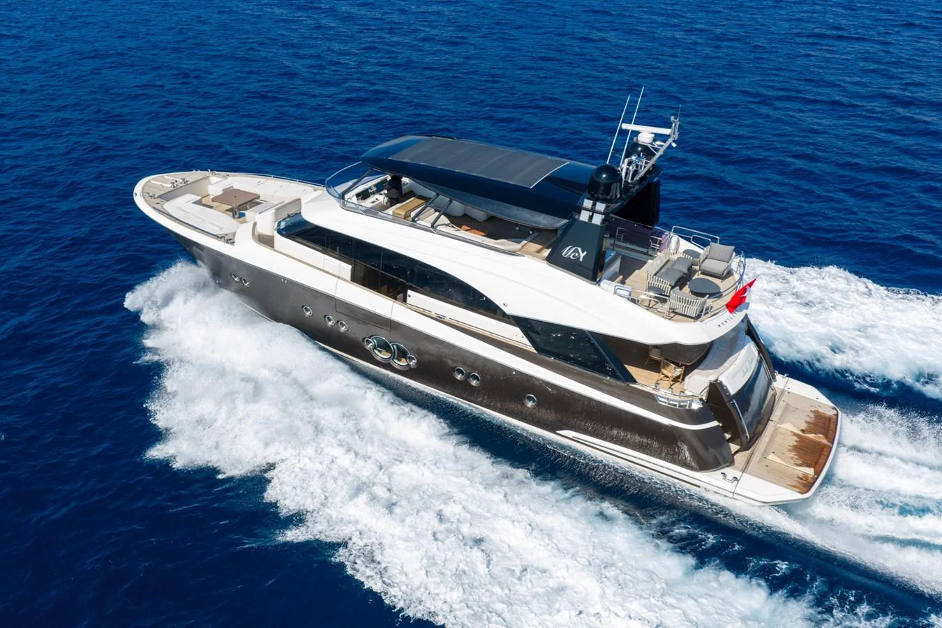 A sleek and modern yacht cruises through the deep blue sea, showcasing its luxurious design and spacious decks. aboard BELLA LUNA Yacht for Sale