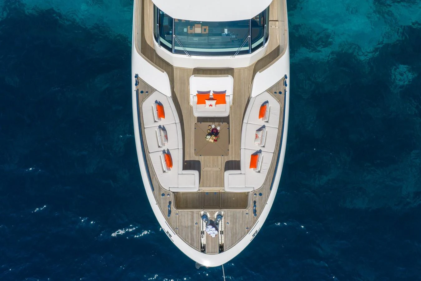 The yacht's foredeck features a spacious seating area with vibrant orange cushions, perfect for relaxation. aboard BELLA LUNA Yacht for Sale