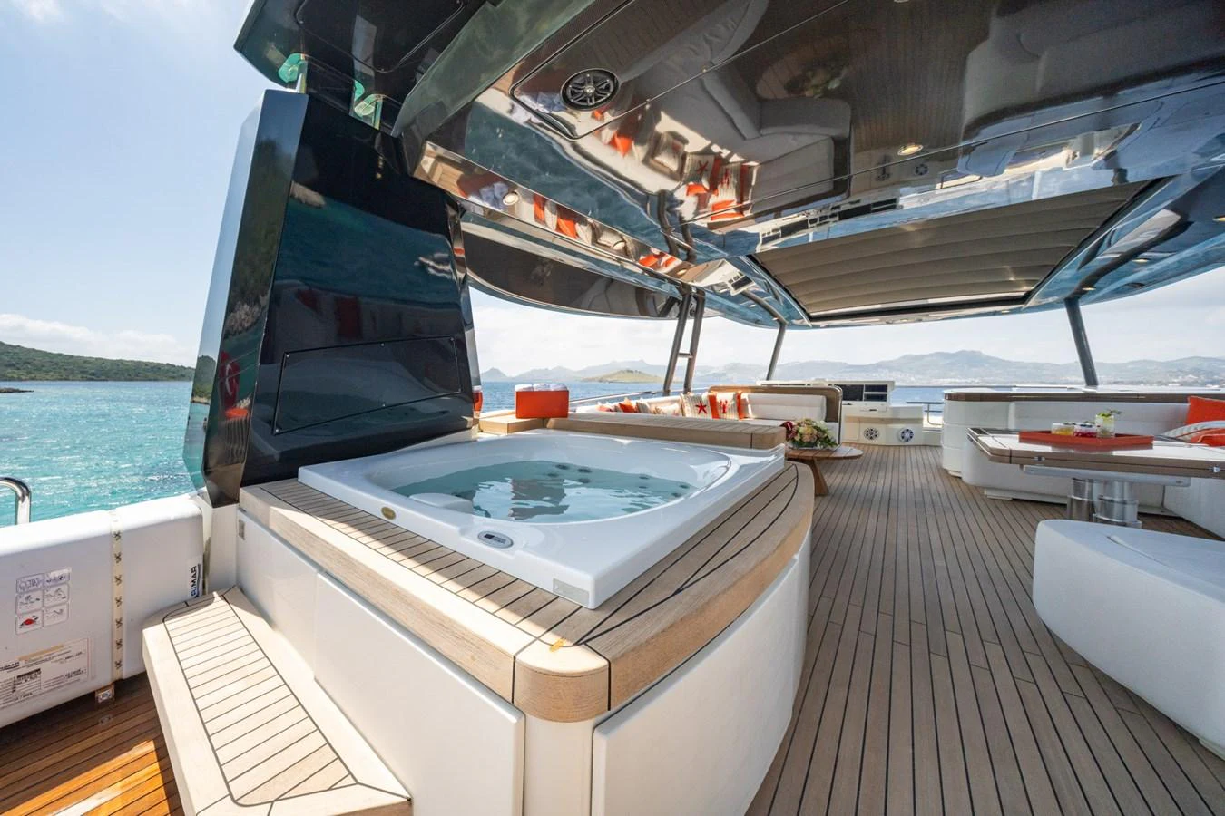 The sundeck features a luxurious hot tub with ample seating and stunning ocean views. aboard BELLA LUNA Yacht for Sale