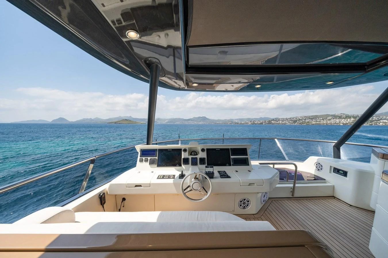 The helm station offers a panoramic view of the sea, equipped with state-of-the-art navigation instruments. aboard BELLA LUNA Yacht for Sale