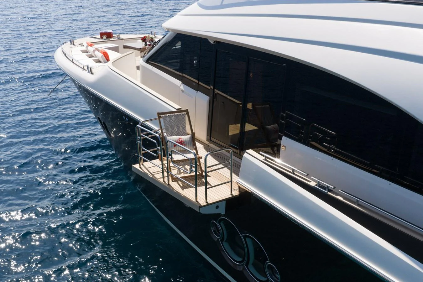 The yacht features a sleek exterior design with a small balcony area overlooking the water. aboard BELLA LUNA Yacht for Sale