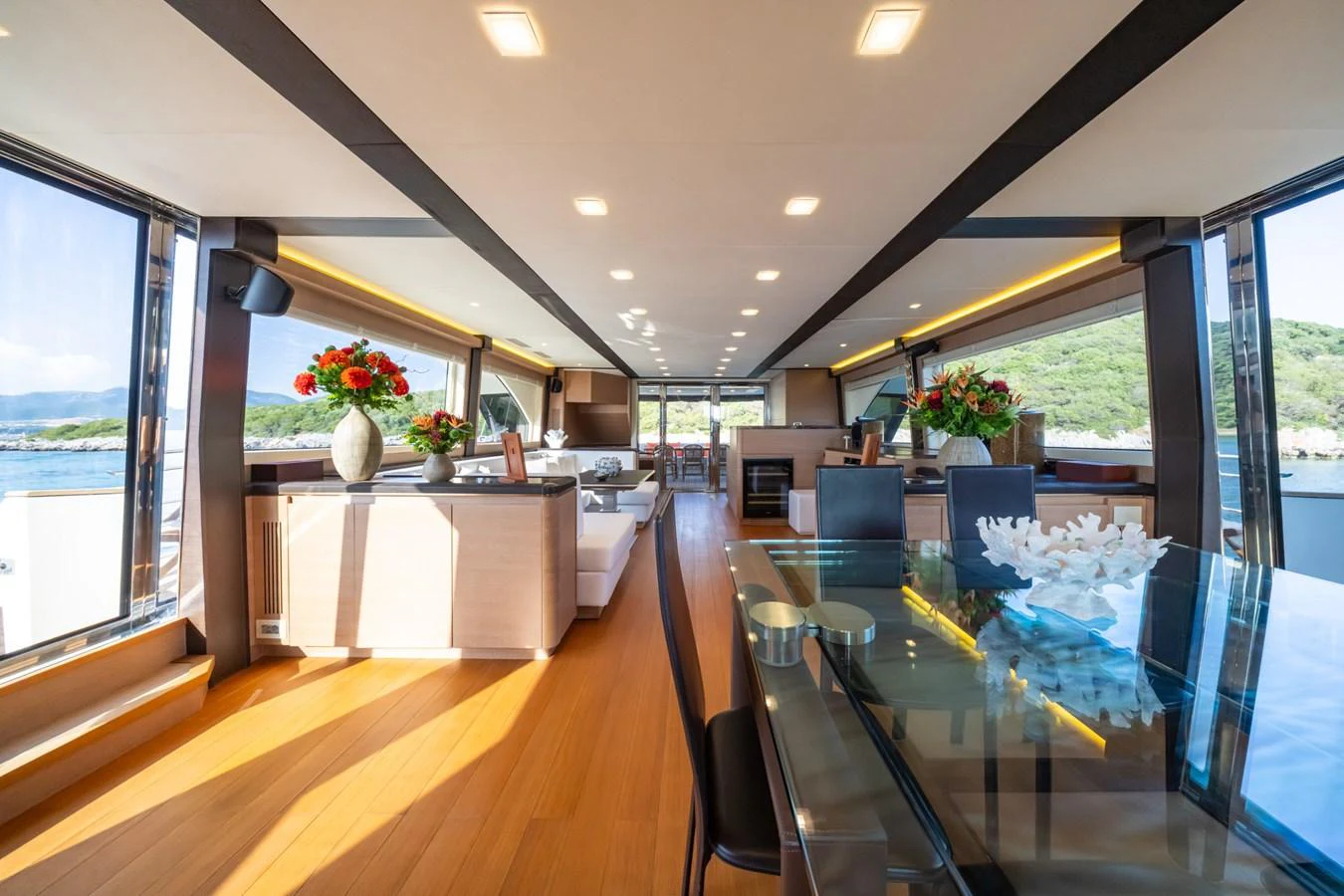 The spacious salon features elegant furnishings and panoramic windows offering stunning views. aboard BELLA LUNA Yacht for Sale