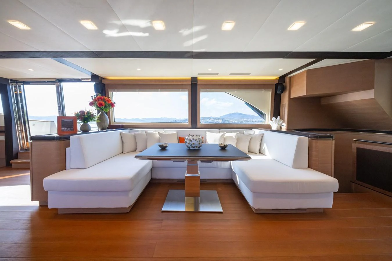 The salon features a spacious and elegant seating area with panoramic views. aboard BELLA LUNA Yacht for Sale