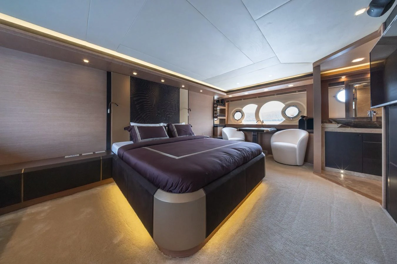 The master stateroom features a luxurious bed with elegant lighting and modern furnishings. aboard BELLA LUNA Yacht for Sale