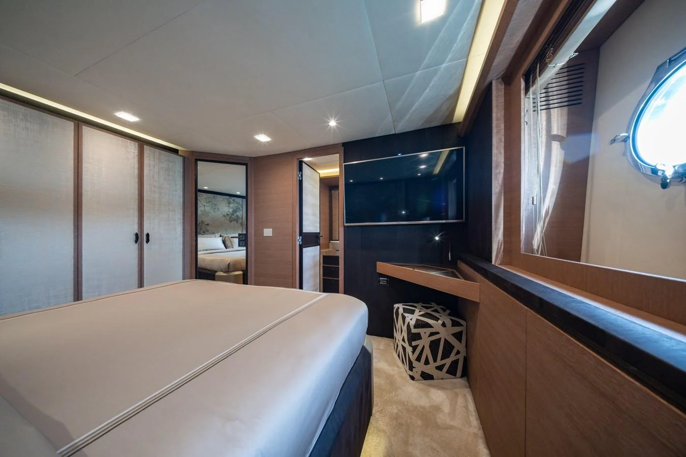 The master stateroom features a luxurious bed, modern furnishings, and ample natural light. aboard BELLA LUNA Yacht for Sale