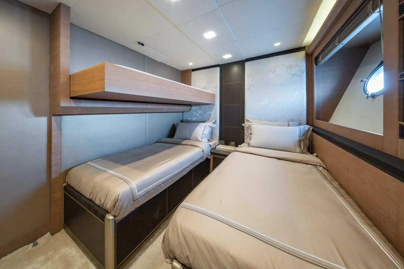 The guest cabin features two single beds with elegant bedding and modern decor. aboard BELLA LUNA Yacht for Sale