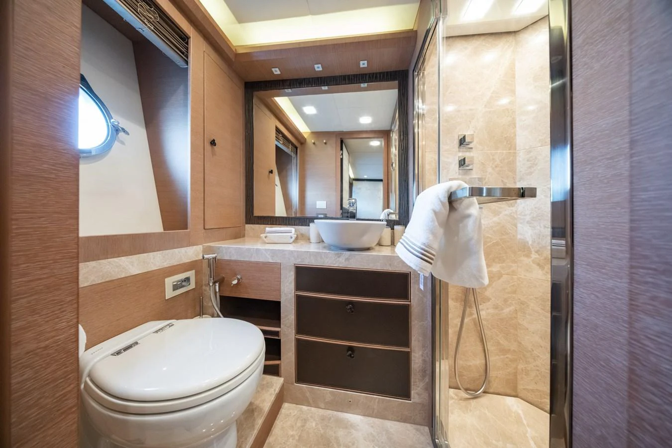 The yacht's bathroom features modern fixtures and elegant wood paneling. aboard BELLA LUNA Yacht for Sale
