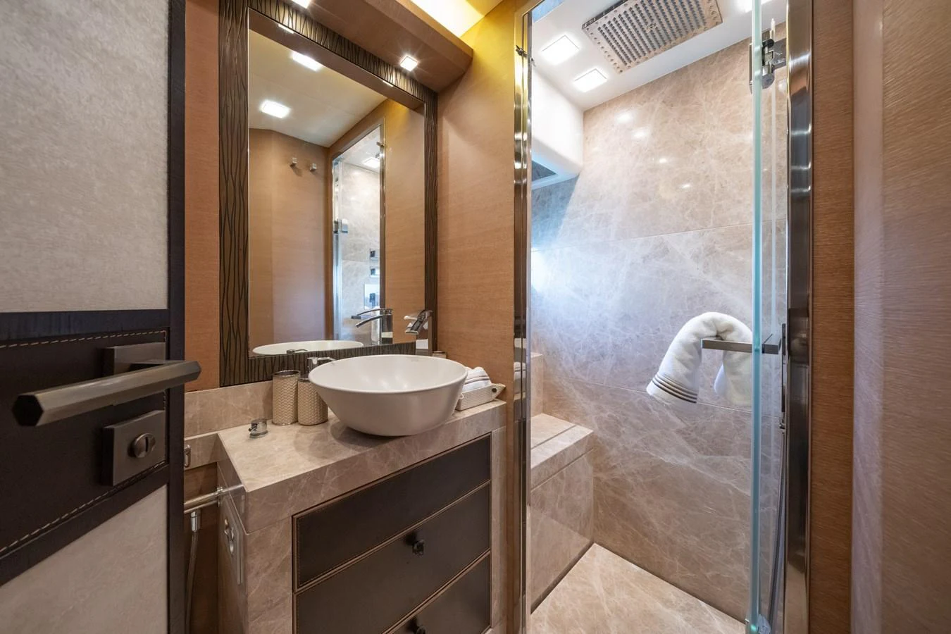 The yacht's bathroom features a modern design with a glass-enclosed shower and elegant fixtures. aboard BELLA LUNA Yacht for Sale