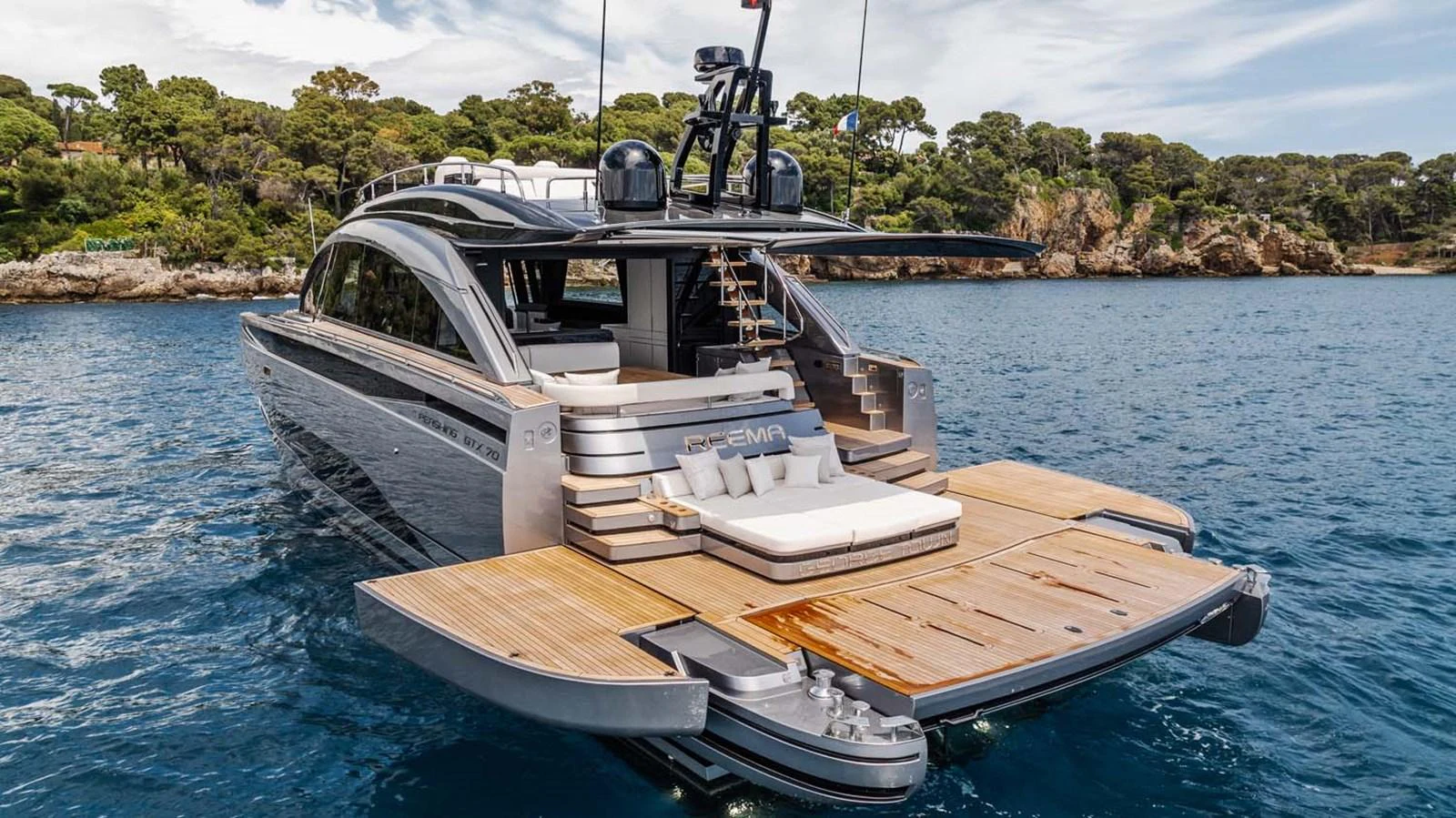 The yacht's aft deck features a spacious lounging area with direct access to the water. aboard REEMA Yacht for Sale