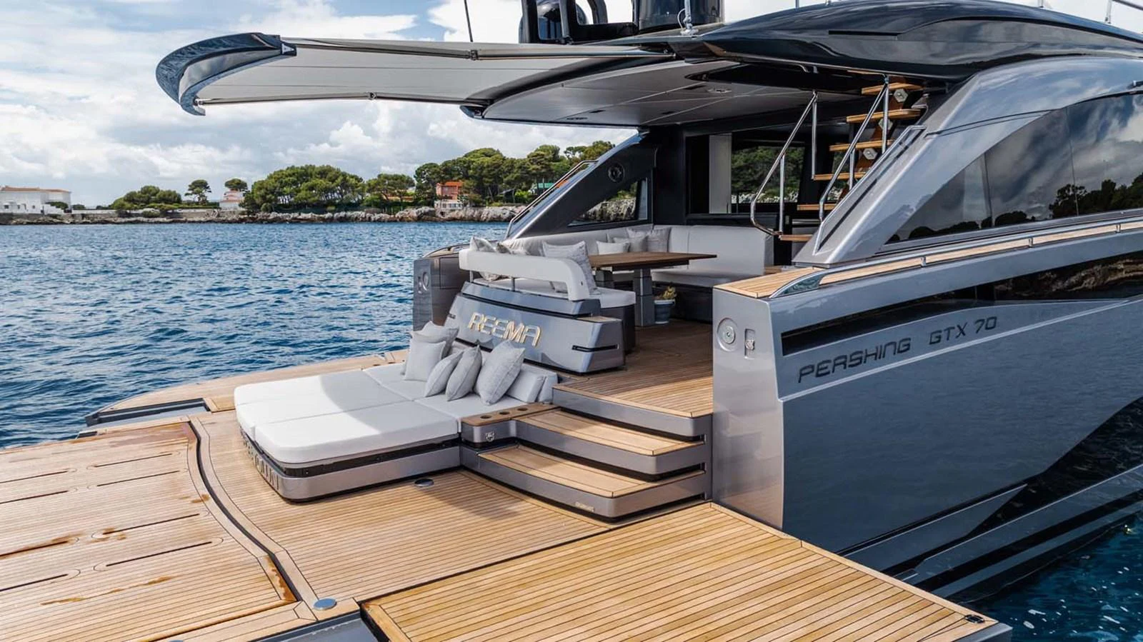 The yacht's aft deck features a luxurious lounging area with direct access to the water. aboard REEMA Yacht for Sale