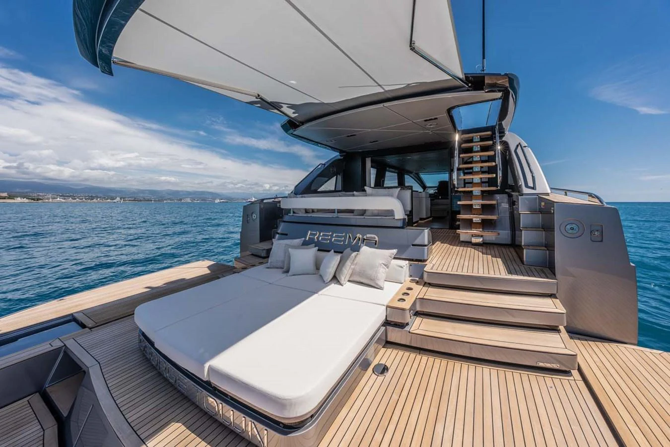 The aft deck features luxurious sunbeds and a shaded lounging area, perfect for relaxation. aboard REEMA Yacht for Sale