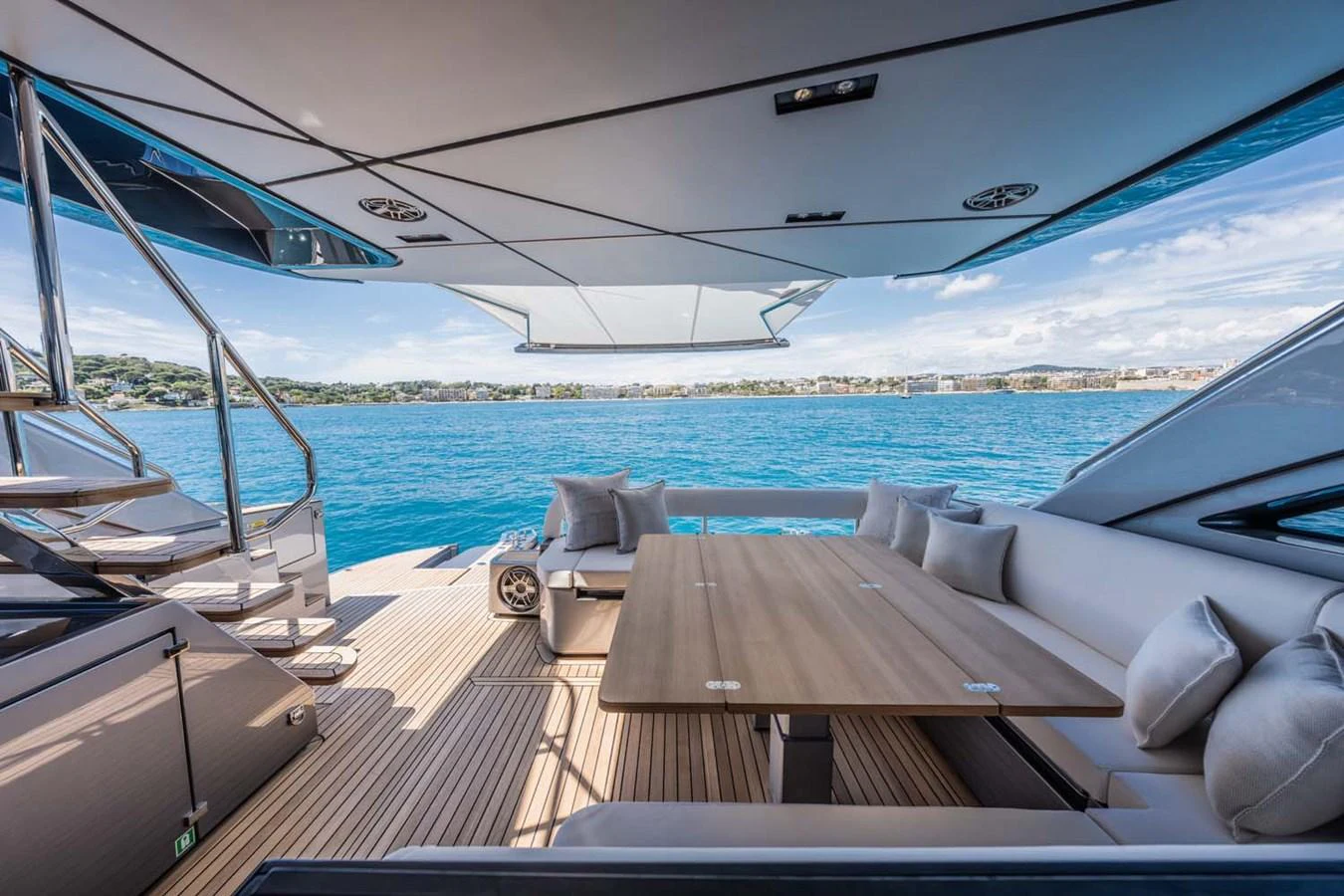 The aft deck features a spacious dining area with a large table and comfortable seating, perfect for alfresco dining with stunning sea views. aboard REEMA Yacht for Sale