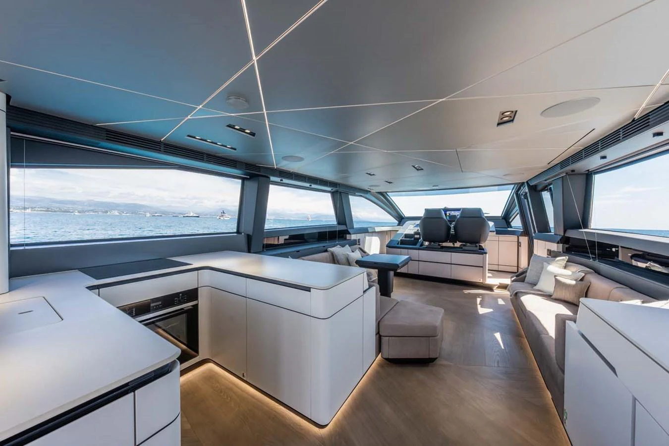 The salon features modern furnishings with panoramic windows offering stunning sea views. aboard REEMA Yacht for Sale