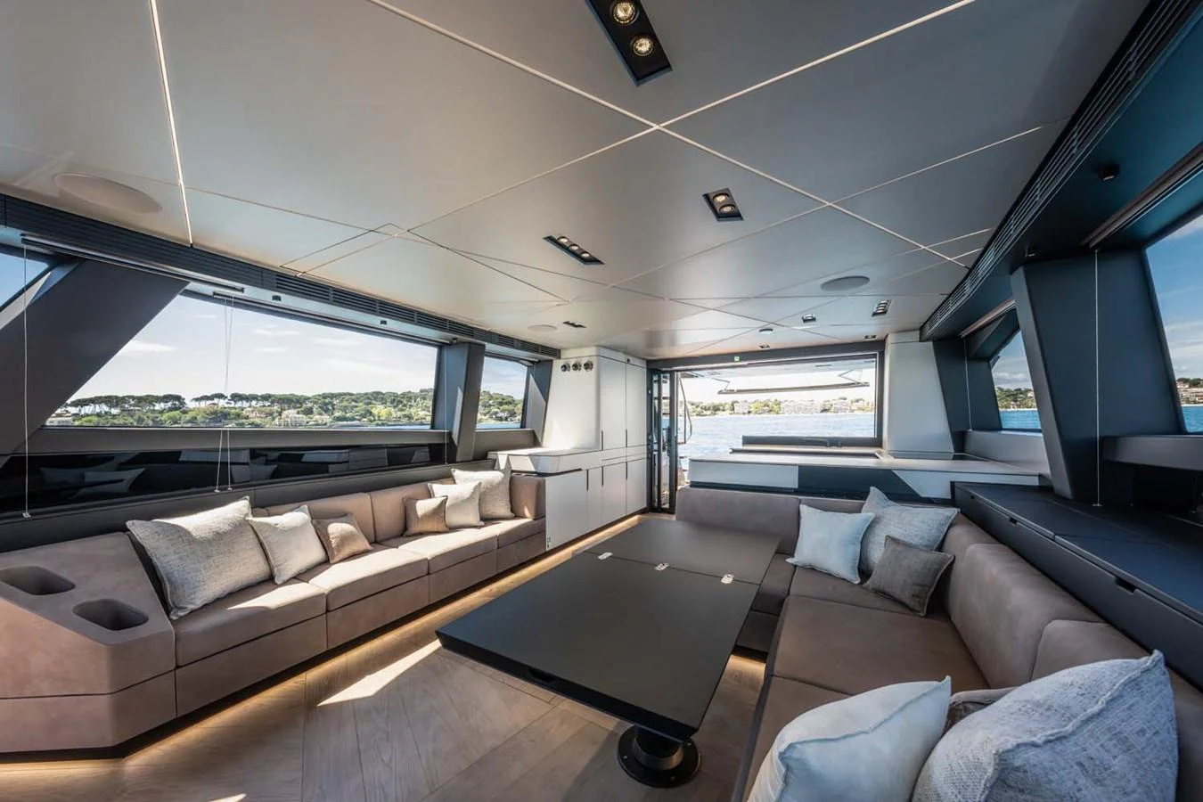 The yacht's salon features modern furnishings with expansive windows offering stunning views. aboard REEMA Yacht for Sale