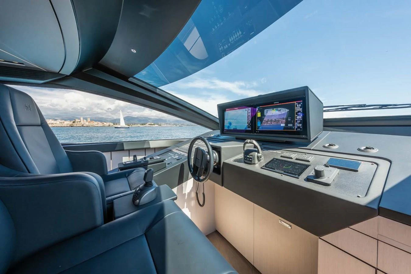 The helm station offers a sleek and modern design with advanced navigation equipment and comfortable seating. aboard REEMA Yacht for Sale