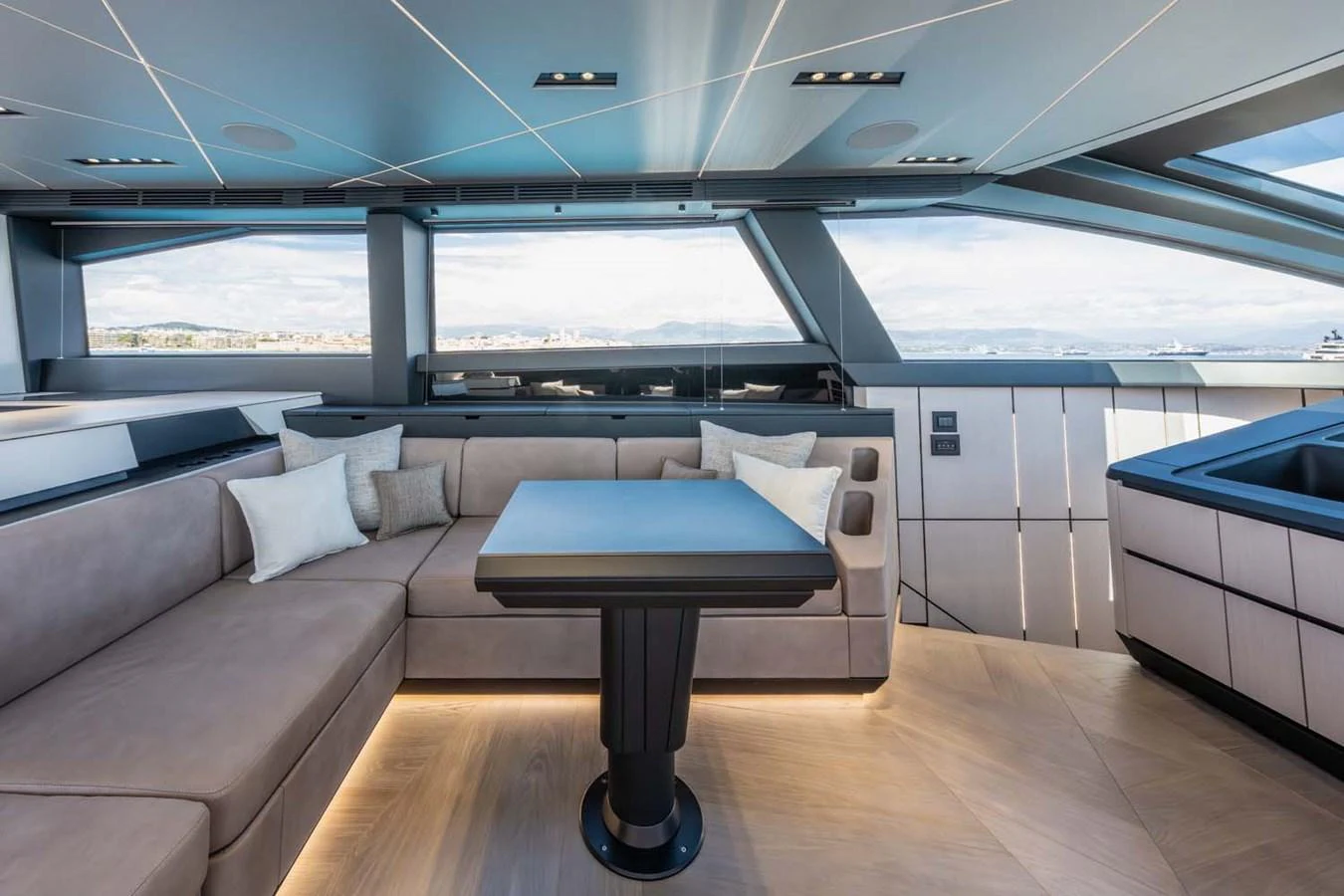 The salon features a modern and spacious seating area with large windows offering panoramic views. aboard REEMA Yacht for Sale