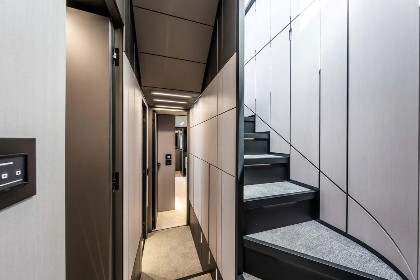 The yacht's interior hallway features modern design with sleek lines and a staircase leading to the upper deck. aboard REEMA Yacht for Sale