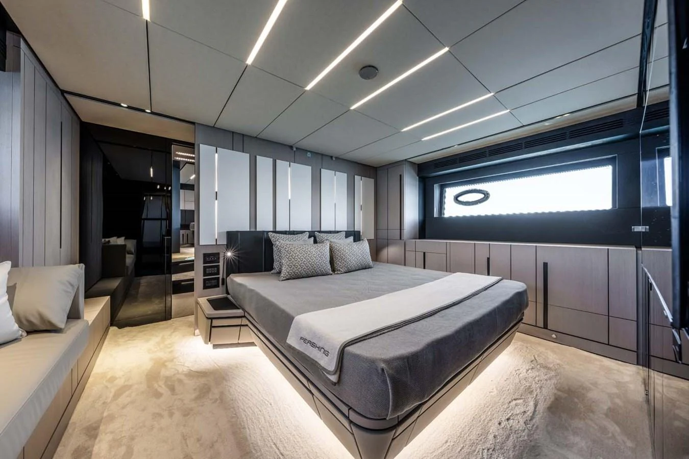 The master stateroom features a luxurious bed with modern lighting and ample storage. aboard REEMA Yacht for Sale
