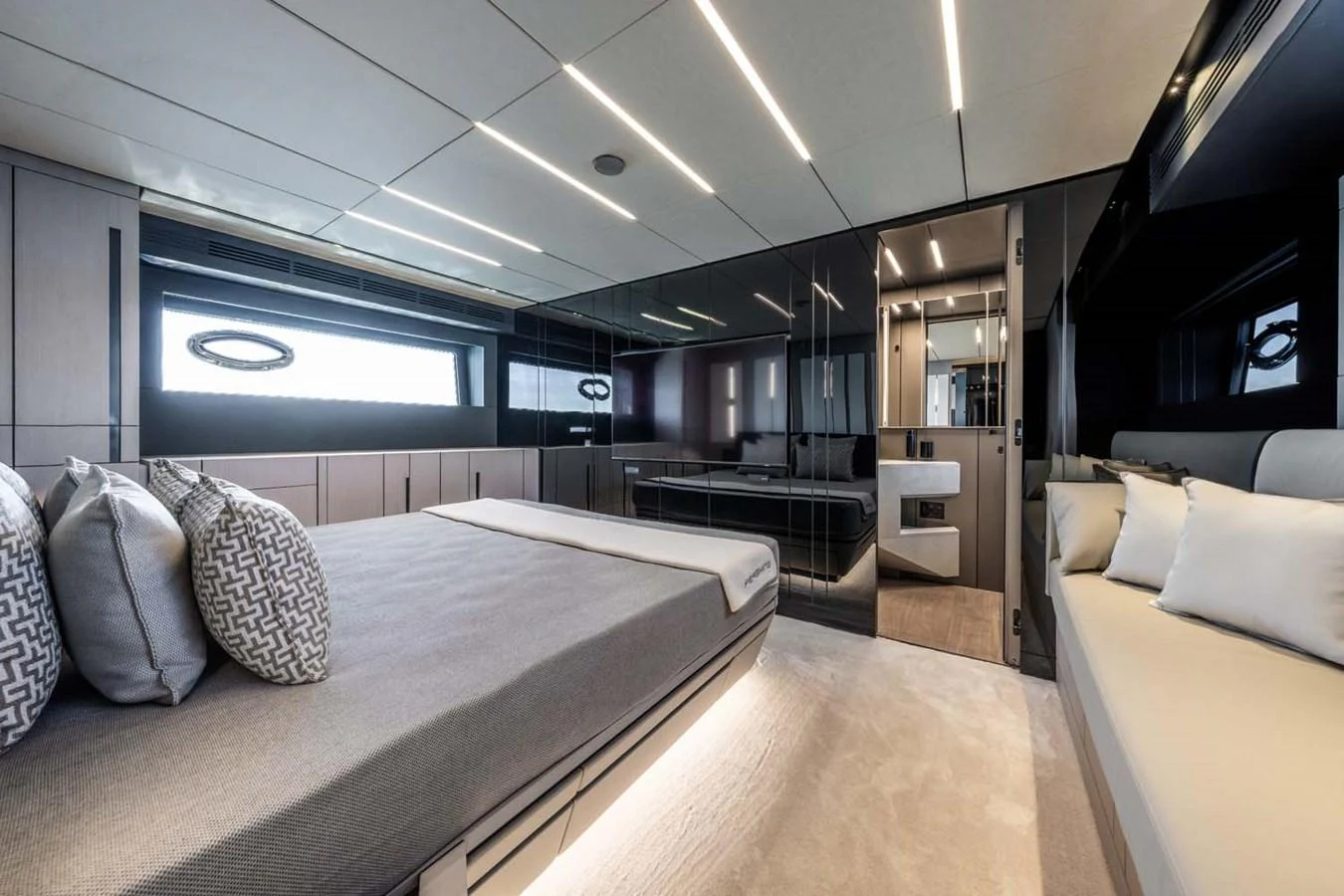 The master stateroom features a luxurious bed, modern lighting, and elegant decor. aboard REEMA Yacht for Sale