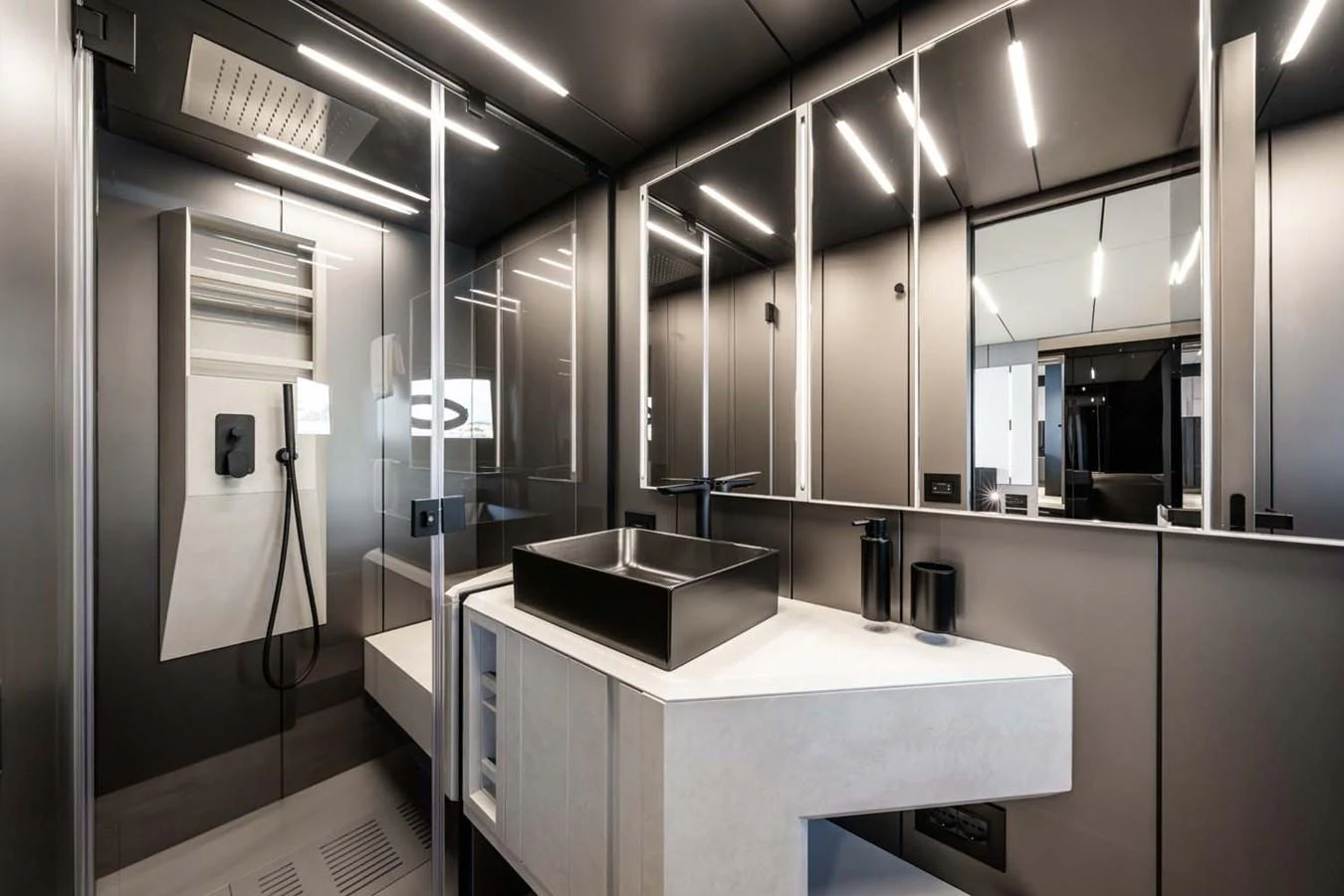 A sleek and modern yacht bathroom with contemporary fixtures and ample mirror space. aboard REEMA Yacht for Sale