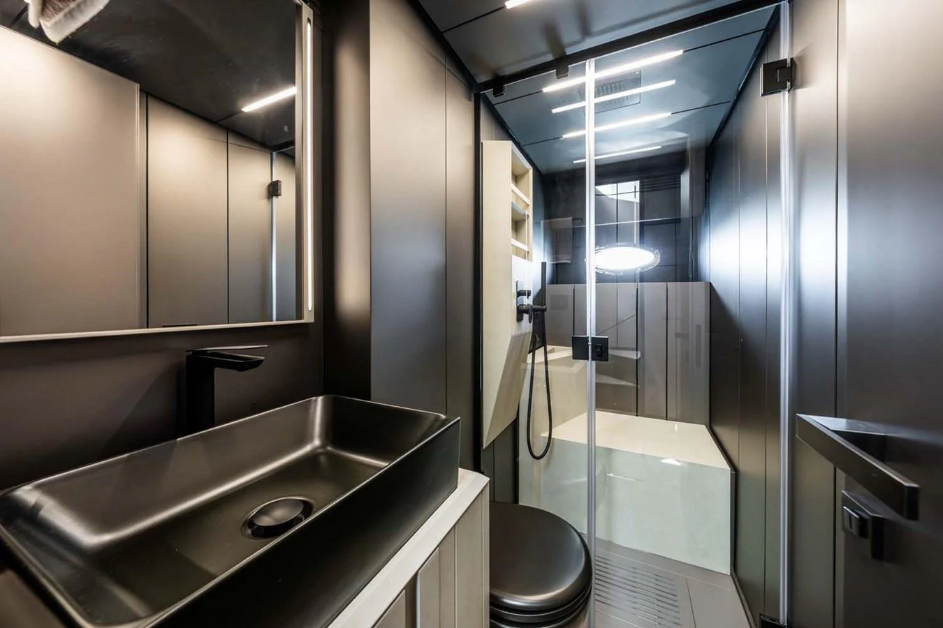 A sleek and modern yacht bathroom with a spacious shower and contemporary fixtures. aboard REEMA Yacht for Sale