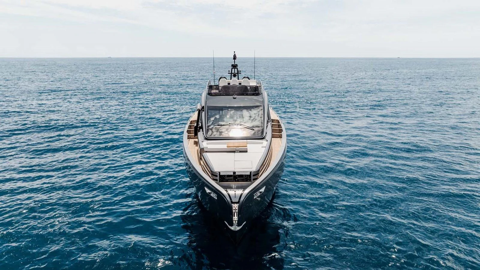 A sleek yacht glides gracefully on the open sea, showcasing its modern design and luxurious appeal. aboard REEMA Yacht for Sale