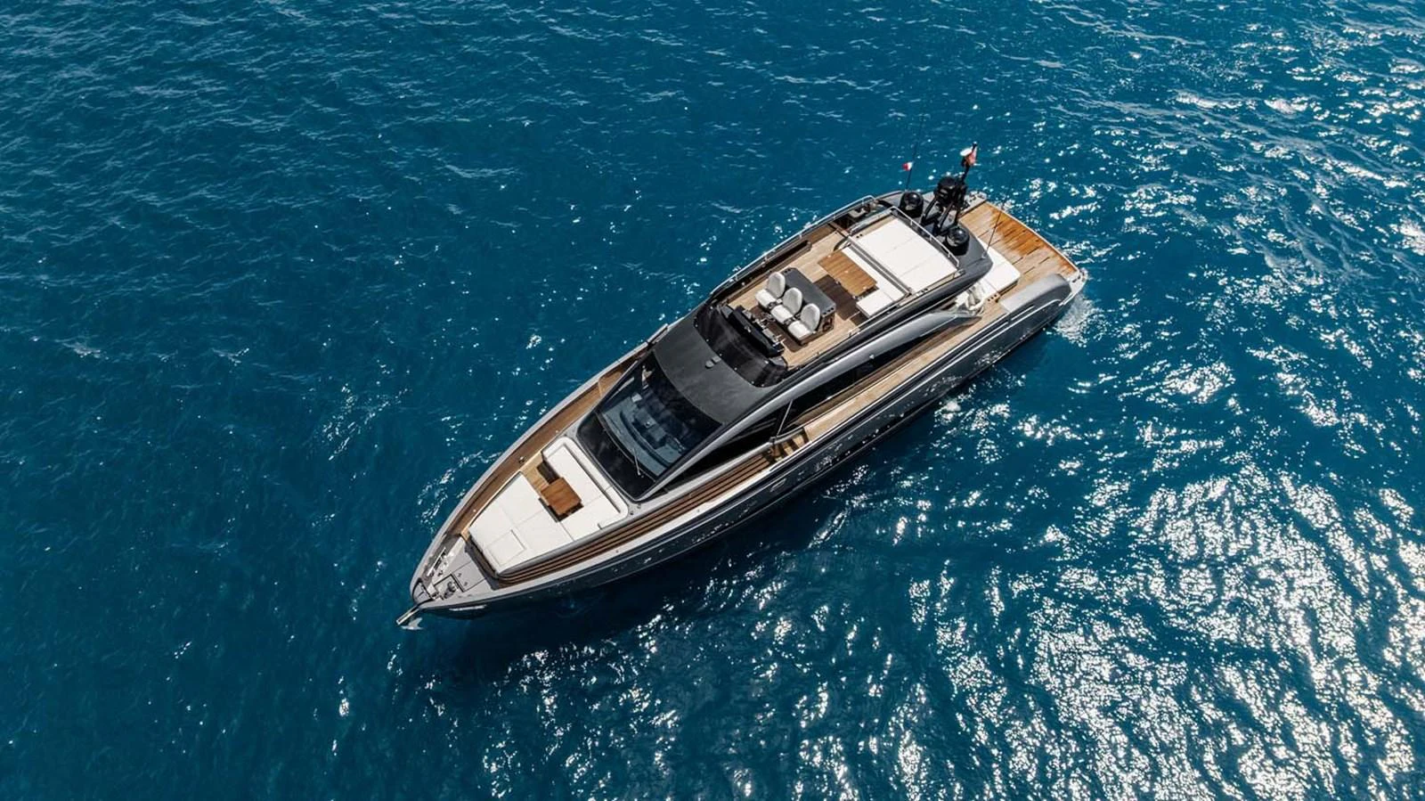 A sleek and modern yacht cruises through the deep blue sea, showcasing its elegant design and luxurious amenities. aboard REEMA Yacht for Sale