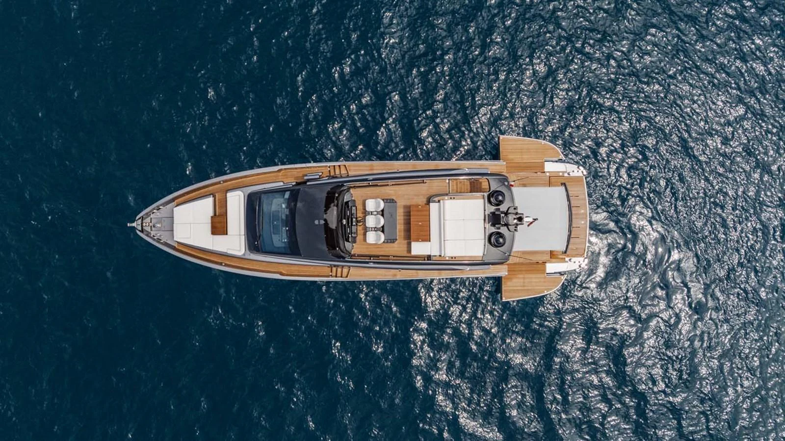 A stunning aerial view of a sleek yacht cruising on the open water. aboard REEMA Yacht for Sale