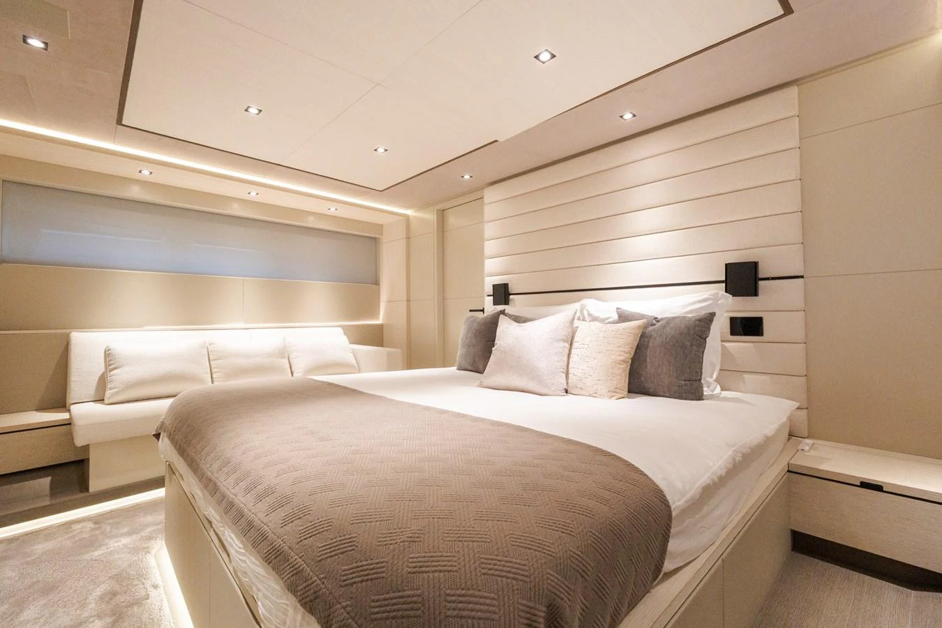 The master stateroom features a luxurious bed with elegant lighting and modern decor. aboard CASA BRI MARE Yacht for Sale