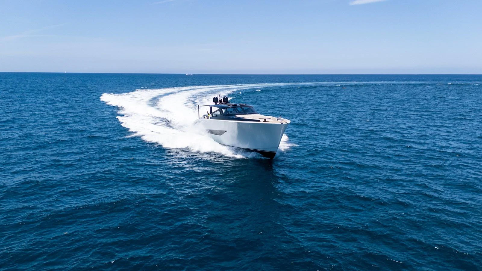 A sleek yacht glides swiftly across the open sea, leaving a trail of white wake behind. aboard CASA BRI MARE Yacht for Sale