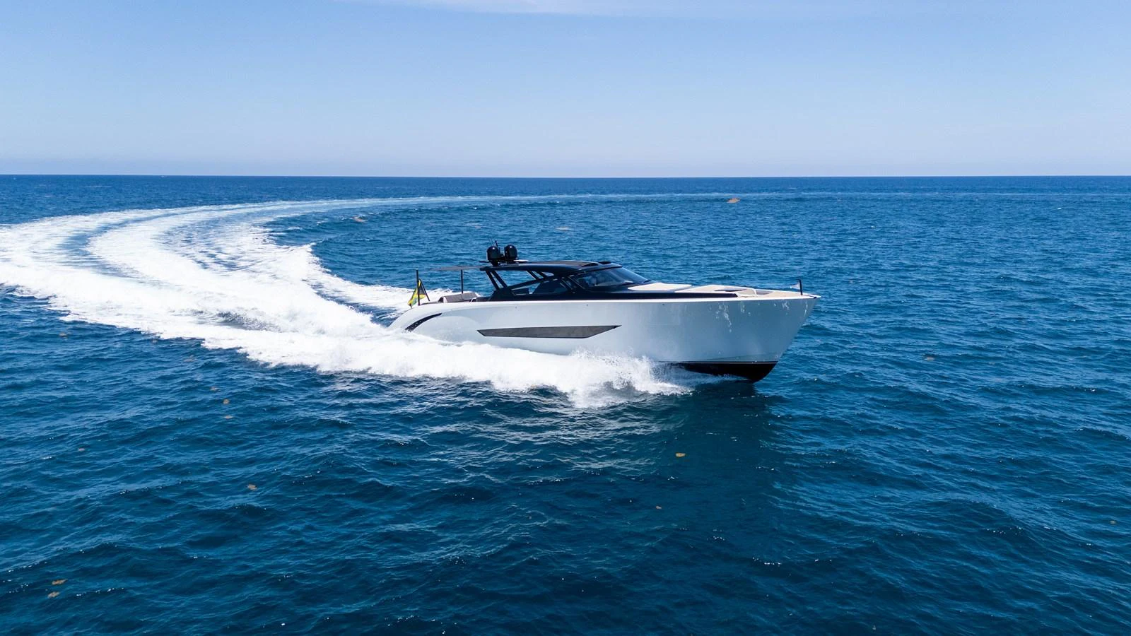 A sleek yacht cruises swiftly across the open sea, leaving a trail of white wake behind. aboard CASA BRI MARE Yacht for Sale