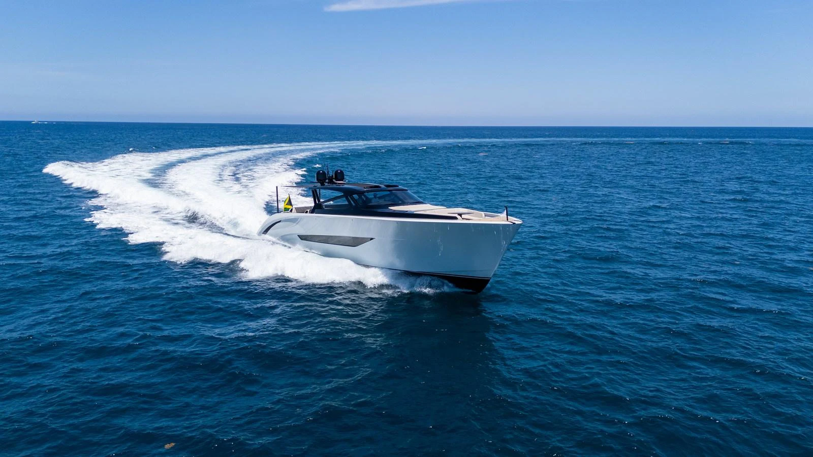 A sleek yacht glides swiftly across the open sea, leaving a trail of white wake behind. aboard CASA BRI MARE Yacht for Sale