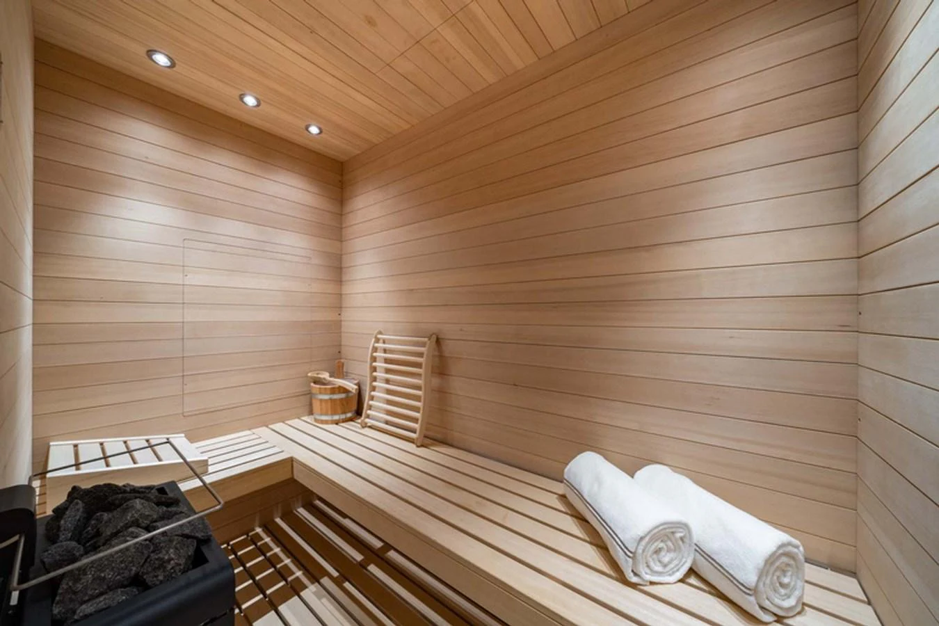 The yacht features a luxurious sauna with wooden interiors and modern amenities. aboard MALIA Yacht for Sale