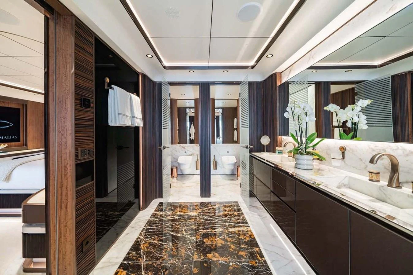 The luxurious bathroom features elegant marble flooring and modern fixtures. aboard MALIA Yacht for Sale