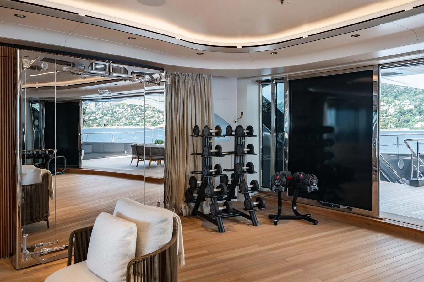 The yacht features a well-equipped gym with a stunning view of the water. aboard MALIA Yacht for Sale