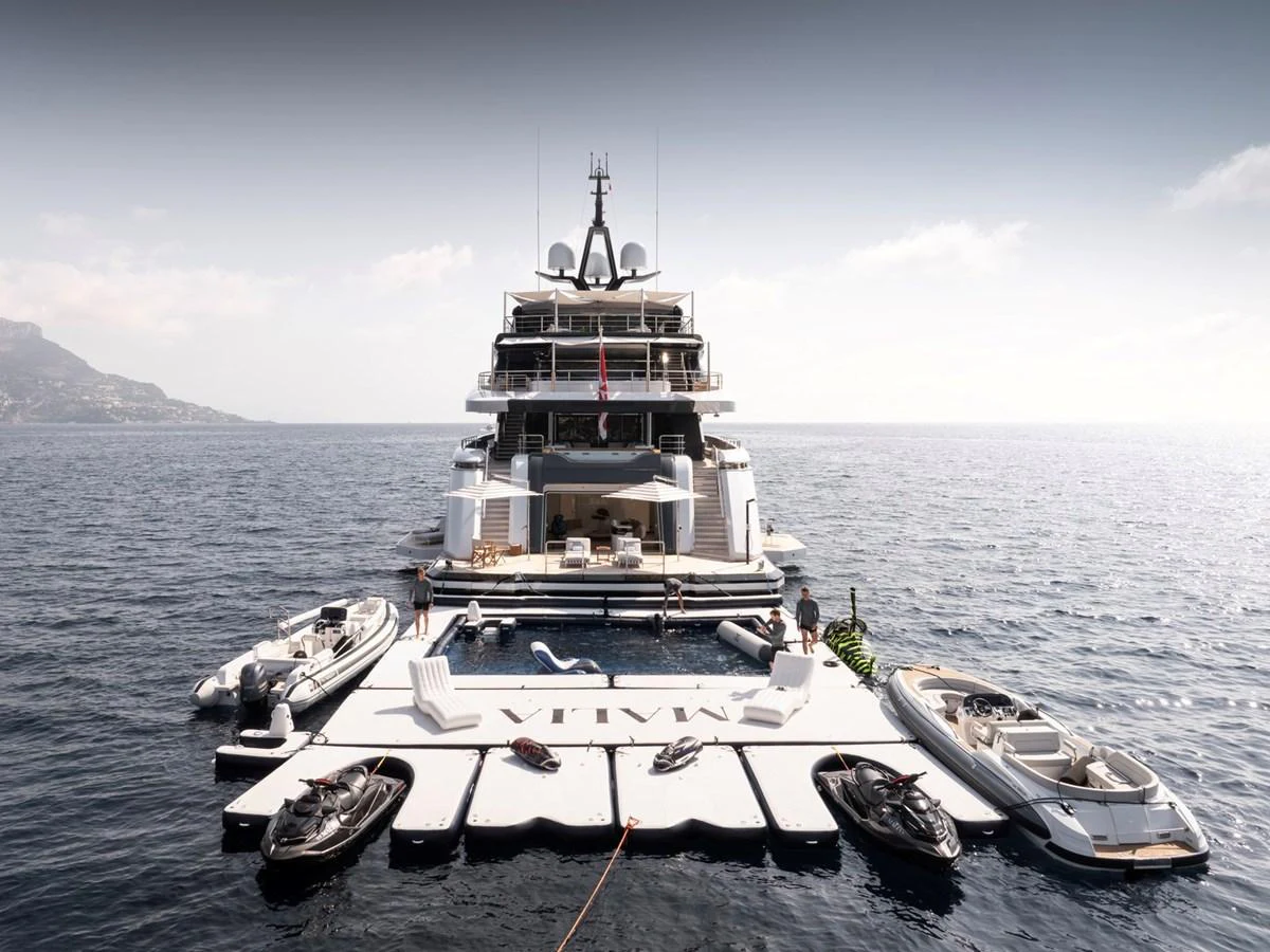 The yacht's aft deck is equipped with an expansive swim platform and various water toys, offering a luxurious and adventurous experience. aboard MALIA Yacht for Sale