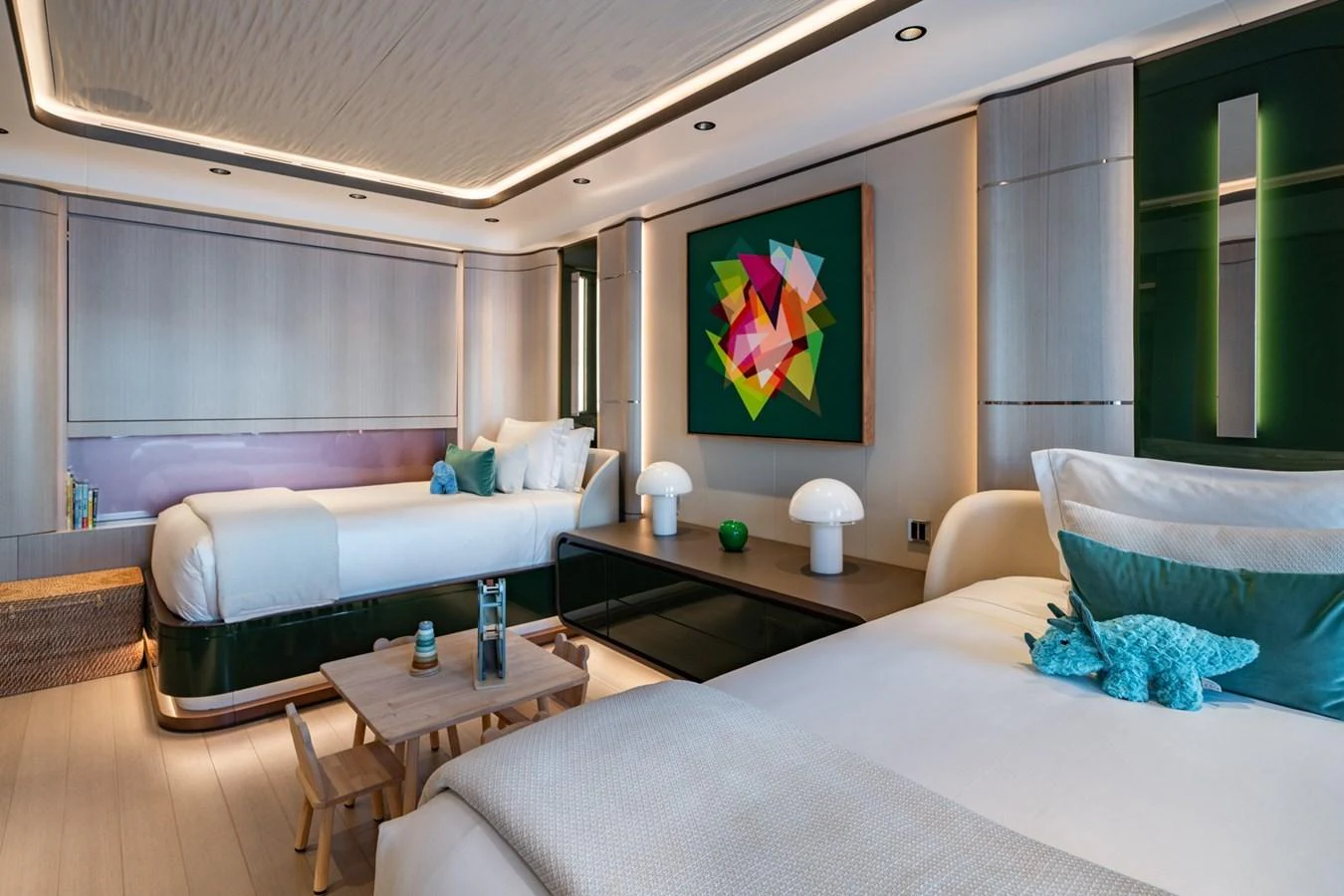 The guest stateroom features twin beds, modern decor, and ambient lighting for a comfortable stay. aboard MALIA Yacht for Sale