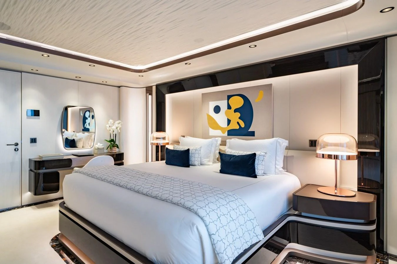 The master stateroom features a luxurious bed with elegant decor and modern lighting. aboard MALIA Yacht for Sale